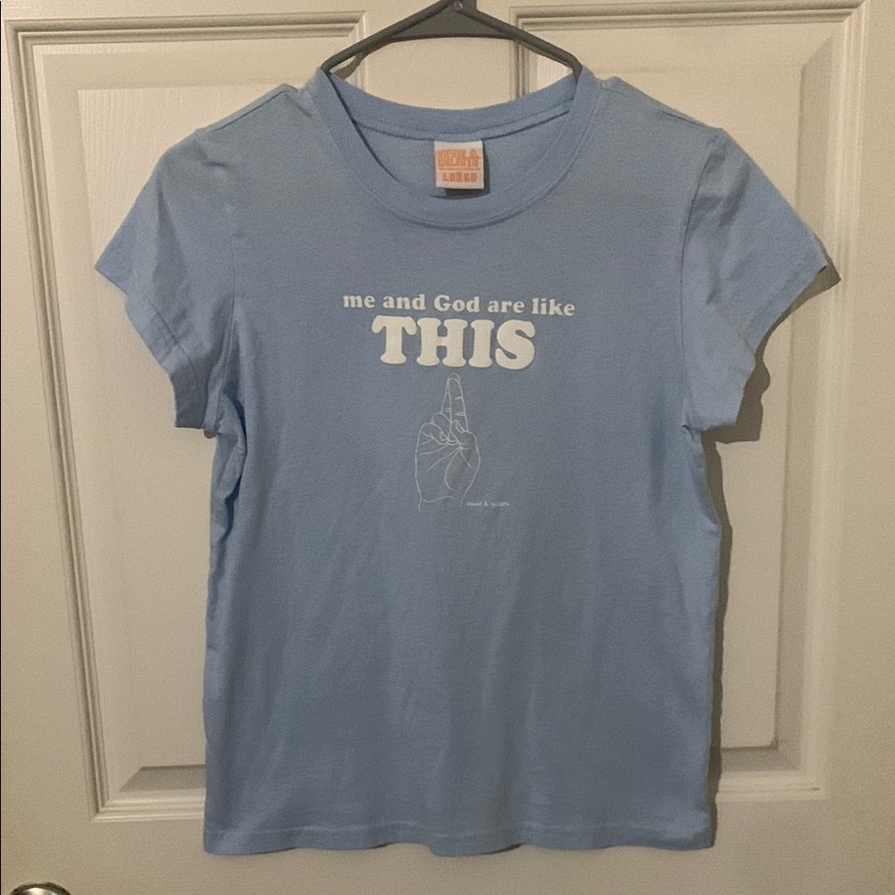 Light Blue David & Goliath Graphic Tee “me and God are like THIS 🤞” Large